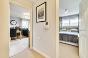 Hallway with doors leading to bedroom and living area.