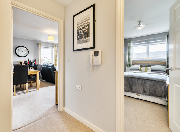Hallway with doors leading to bedroom and living area.
