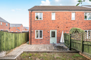Rear garden with paved patio, outdoor seating and fenced boundaries.