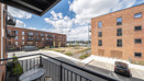 Balcony view overlooking apartment buildings and looking onto river.