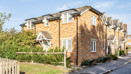 Brick end-of-terrace house with parking area and landscaped frontage.
