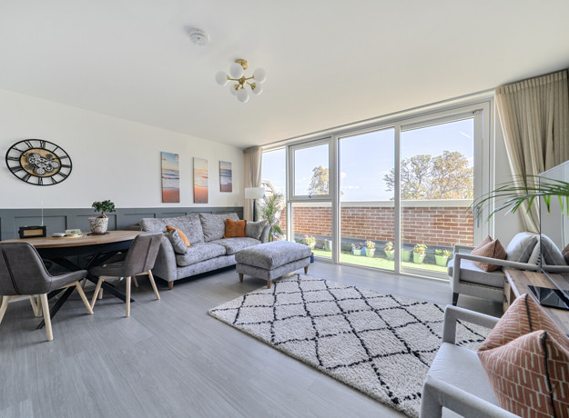 Open-plan living area with dining space and balcony doors.
