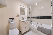 Bathroom with bath, shower, toilet and vanity unit.