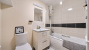 Bathroom with bath, shower, toilet and vanity unit.