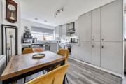 Kitchen and dinning area with dining table and fitted kitchen units.
