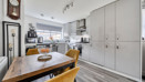 Kitchen and dinning area with dining table and fitted kitchen units.