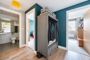 Hallway with storage, leading into bedrooms and bathroom.