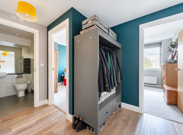 Hallway with storage, leading into bedrooms and bathroom.