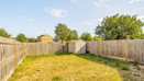 Enclosed rear garden with lawn, wooden fencing and a garden shed.