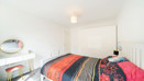 Double bedroom with bed, wardrobe and natural light.