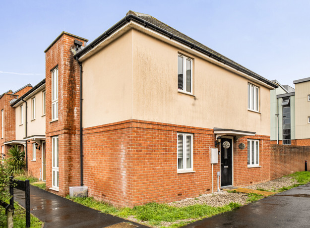 End-of-terrace house with brick and rendered exterior beside a footpath.