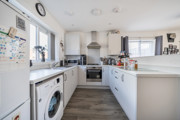 Modern white kitchen with appliances, wooden worktops and appliances.