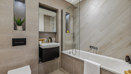 Modern bathroom with bath and vanity unit in the Horlicks Quarter show home in Slough