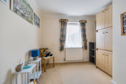 Bedroom with wardrobes, chair, desk and window.
