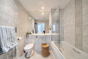 Bathroom with bath, shower screen, toilet and wash basin.