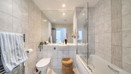 Bathroom with bath, shower screen, toilet and wash basin.