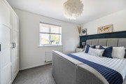 Bedroom with a double bed, wardrobe and window.