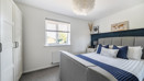 Bedroom with a double bed, wardrobe and window.