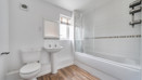 Bathroom with bath, shower, wash basin and toilet.