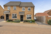Semi-detached house with driveway and small front garden.