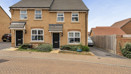 Semi-detached house with driveway and small front garden.