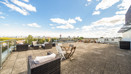 Roof terrace with outdoor seating, tables and surrounding views.