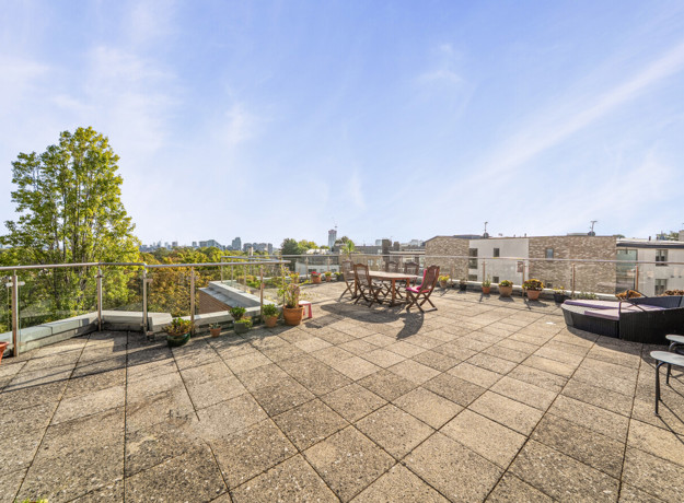 Private terrace with outdoor seating and views across neighbouring buildings.