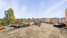 Private terrace with outdoor seating and views across neighbouring buildings.