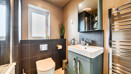 Contemporary bathroom with shower, basin, mirror, WC and towel rail.