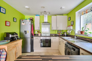 Kitchen with fitted units, appliances and window above the sink.