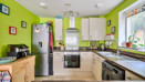 Kitchen with fitted units, appliances and window above the sink.