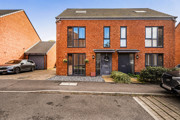 Semi-detached red brick house with driveway and parking spaces.