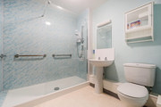 Bathroom with walk-in shower, toilet and sink.