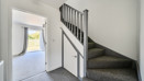 Entrance hall with staircase and doorway to living room.