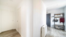 Entrance hallway with wood-effect flooring and storage space.