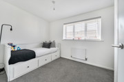 Bedroom with a single bed, radiator and window with blinds.
