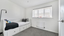 Bedroom with a single bed, radiator and window with blinds.