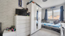 Bedroom with children's bed, wardrobe, dresser, and window with blinds.