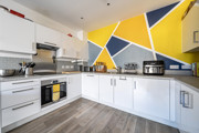 Fitted kitchen with oven, hob, worktops and wall cabinets.