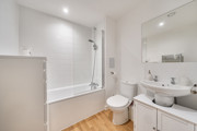 Bathroom with bath, shower, toilet and wash basin.