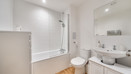 Bathroom with bath, shower, toilet and wash basin.